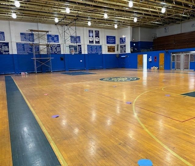 Empty indoor basketball court with blue walls