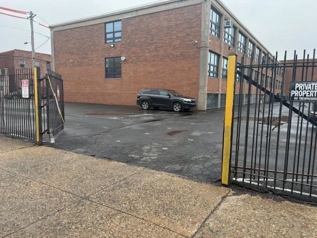 Private gated parking lot with parked SUV